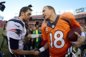 Peyton Manning and Tom Brady shake hands amidst the Brady vs Manning rivalry