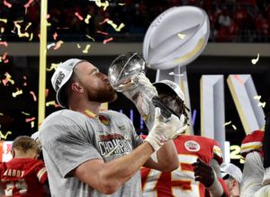 Travis Kelce of the Kansas City Chiefs holds the Lombardi Trophy for winning the Super Bowl in 2020.